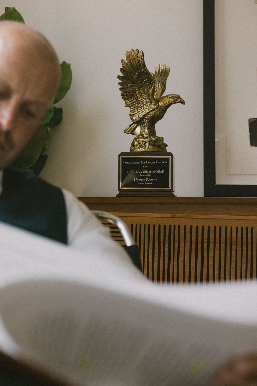 Gold eagle trophy award displayed on wooden shelf.