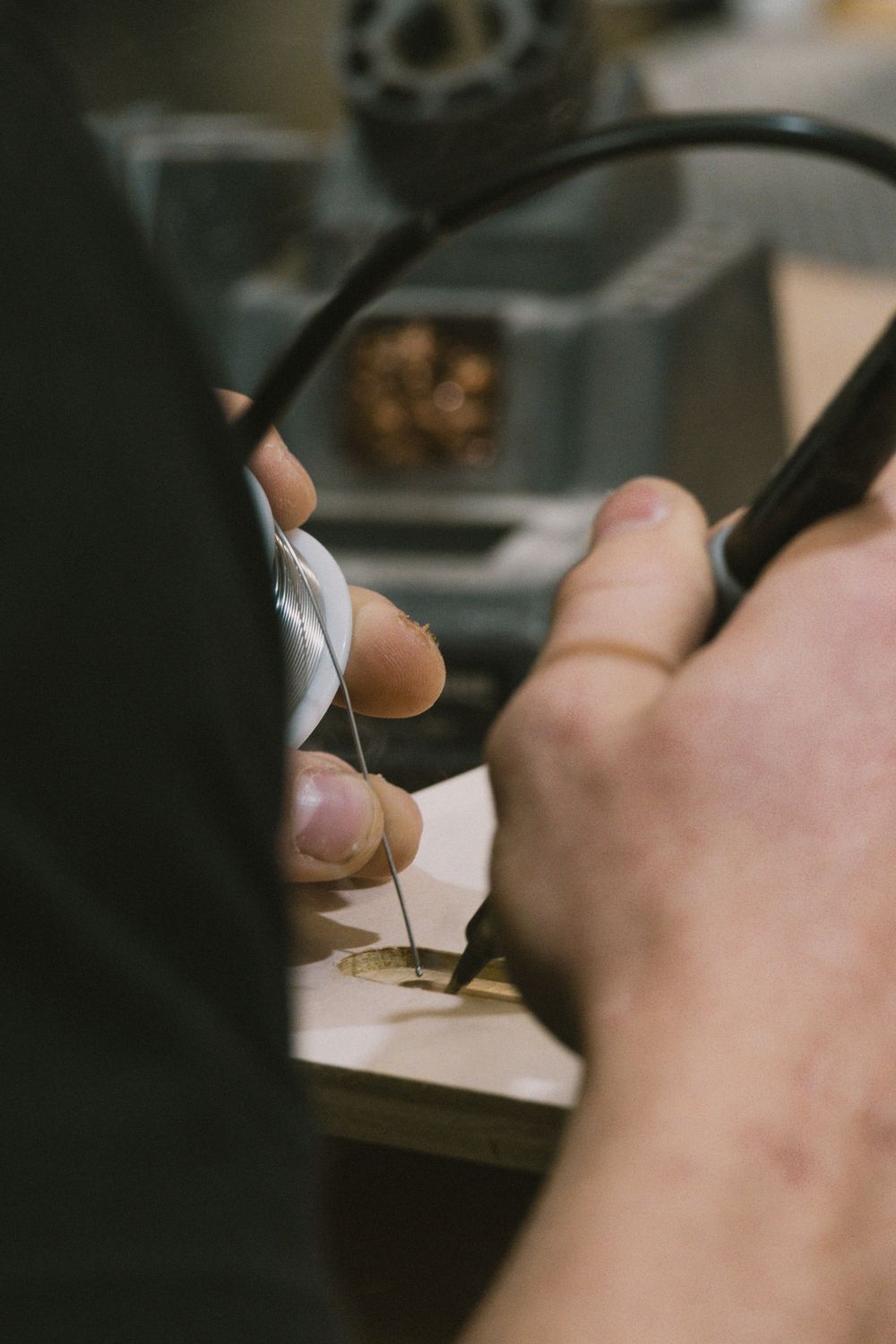 Close-up shot of hands using measuring tools on a wooden surface.