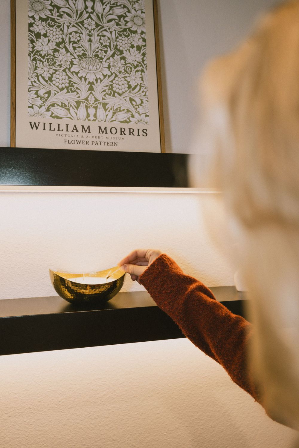 William Morris floral pattern designs displayed on a white wall.
