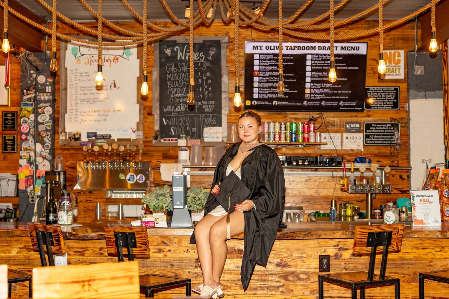 Rustic brewery interior with wooden decor and chalkboard menus on brick walls (Goldsboro, NC).