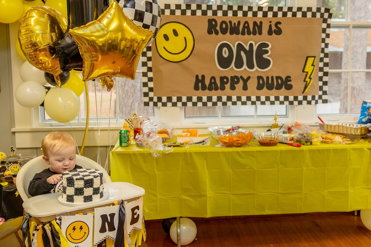 Yellow and black checkered birthday party decorations with smiley face theme (Willard, NC).
