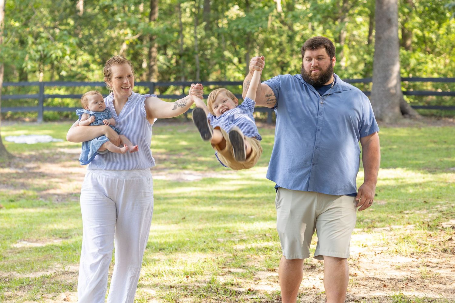 Family members play and laugh together in a sunny outdoor park setting (Roseboro, NC).