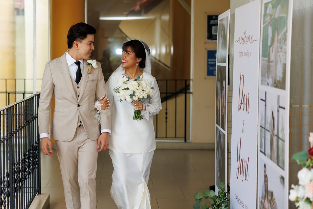Formal wedding ceremony in indoor venue with elegant decor and lighting.
