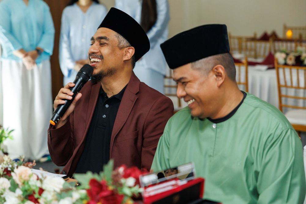 Wedding ceremony speakers in traditional attire addressing guests.