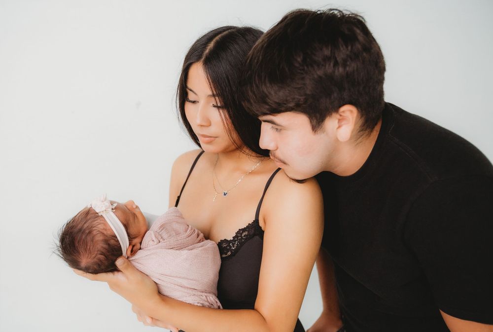 A series of intimate photos showing tender moments between parents and their newborn baby in soft, natural lighting.