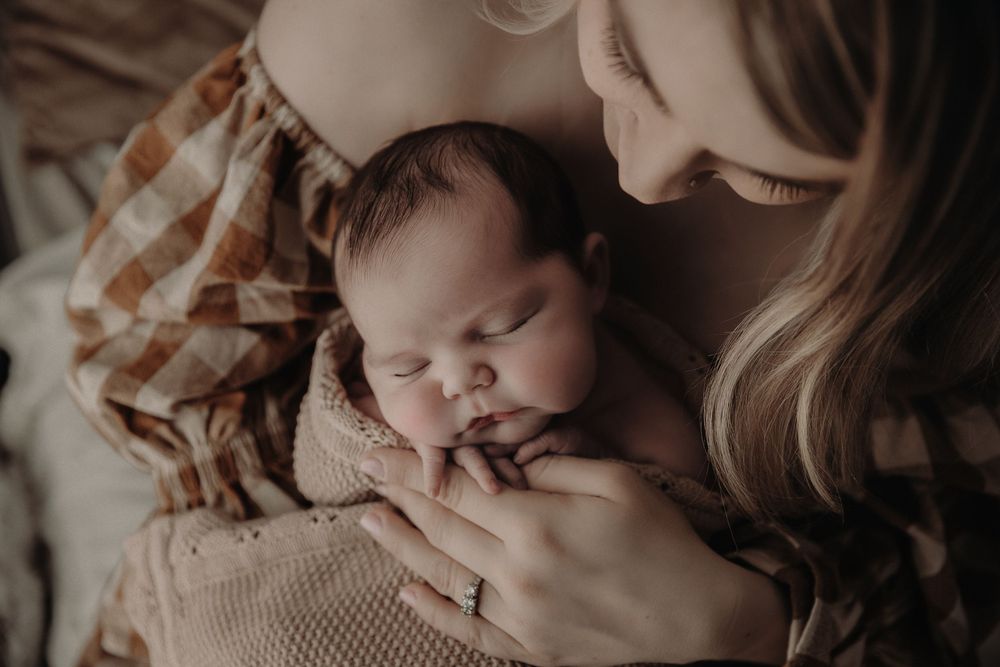 A series of intimate lifestyle photos showing a baby sleeping peacefully in soft beige tones.