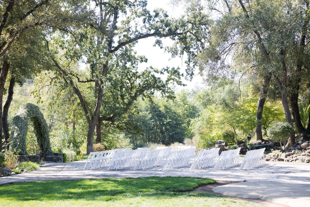 Panoramic view of a lush green park with winding pathways and mature trees.