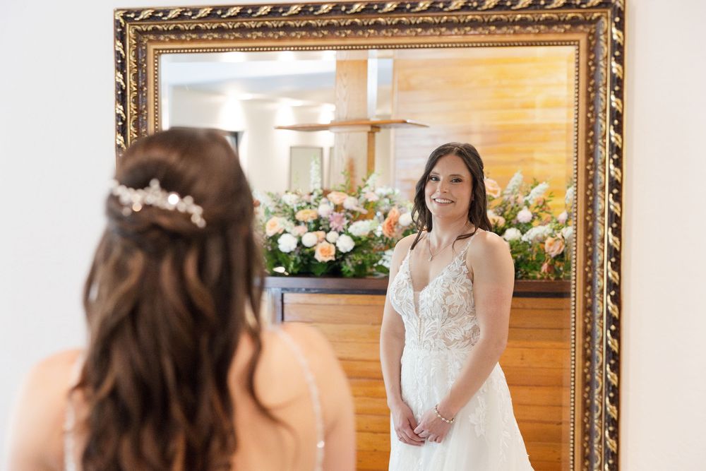 Wedding preparation details with elegant decor and floral arrangements in a sunlit room.