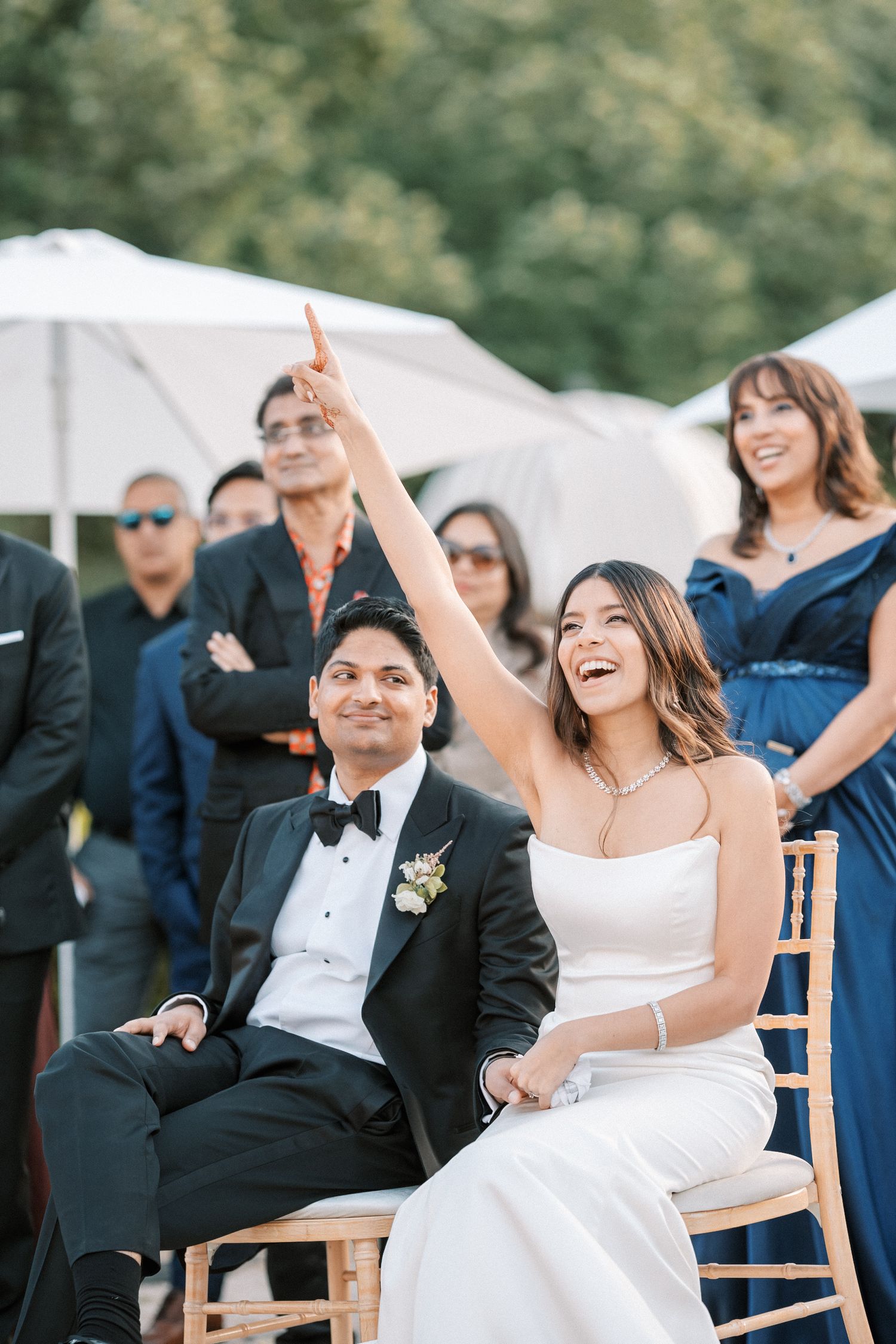 Bride laughing during wedding game at garden cocktail hour in palcio correio mor in Portugal