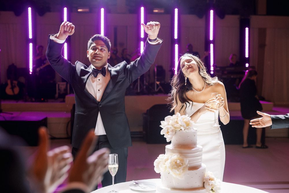 Elegant cake cutting under chandeliers at Correio-Mor palace wedding in Portugal