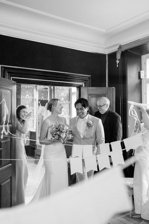 Black and white photo sequence showing wedding preparation moments in a bright interior room with natural light.