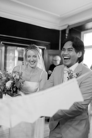 Candid sequence of a joyful wedding couple sharing laughter and embraces in black and white photography.
