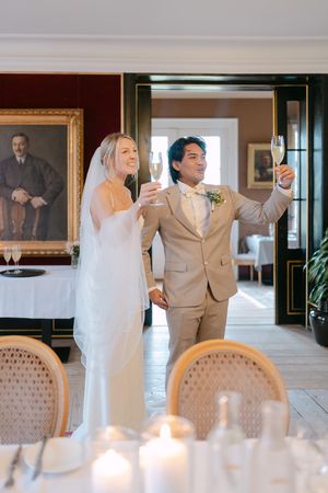 Wedding celebration in an upscale dining room with candles, formal portraits and elegant furnishings.