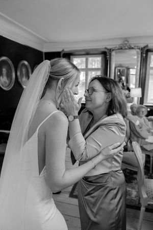 A sequence of black and white photographs showing an emotional moment between a bride and a loved one.