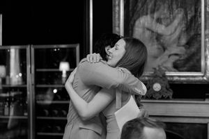 A couple shares a romantic dance in an intimate setting with soft lighting and warm ambiance.
