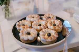 White frosted mini bundt cakes arranged on plates for a wedding dessert display.