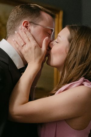 A sequence of intimate moments captured in dark moody lighting showing a romantic kiss between a couple.