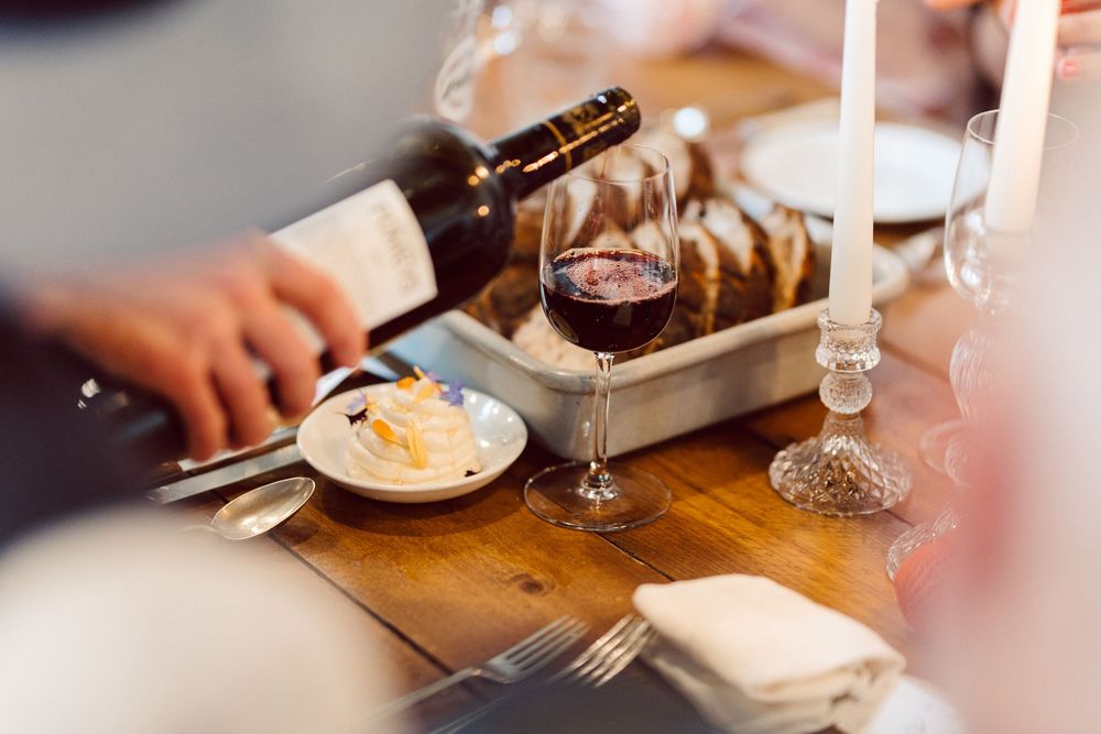 A wooden table set with plates and utensils for a casual dining experience.