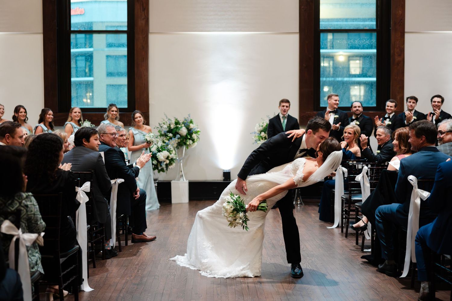 A sequence of wedding ceremony photos showing a couple during their first dance at an elegant indoor venue.