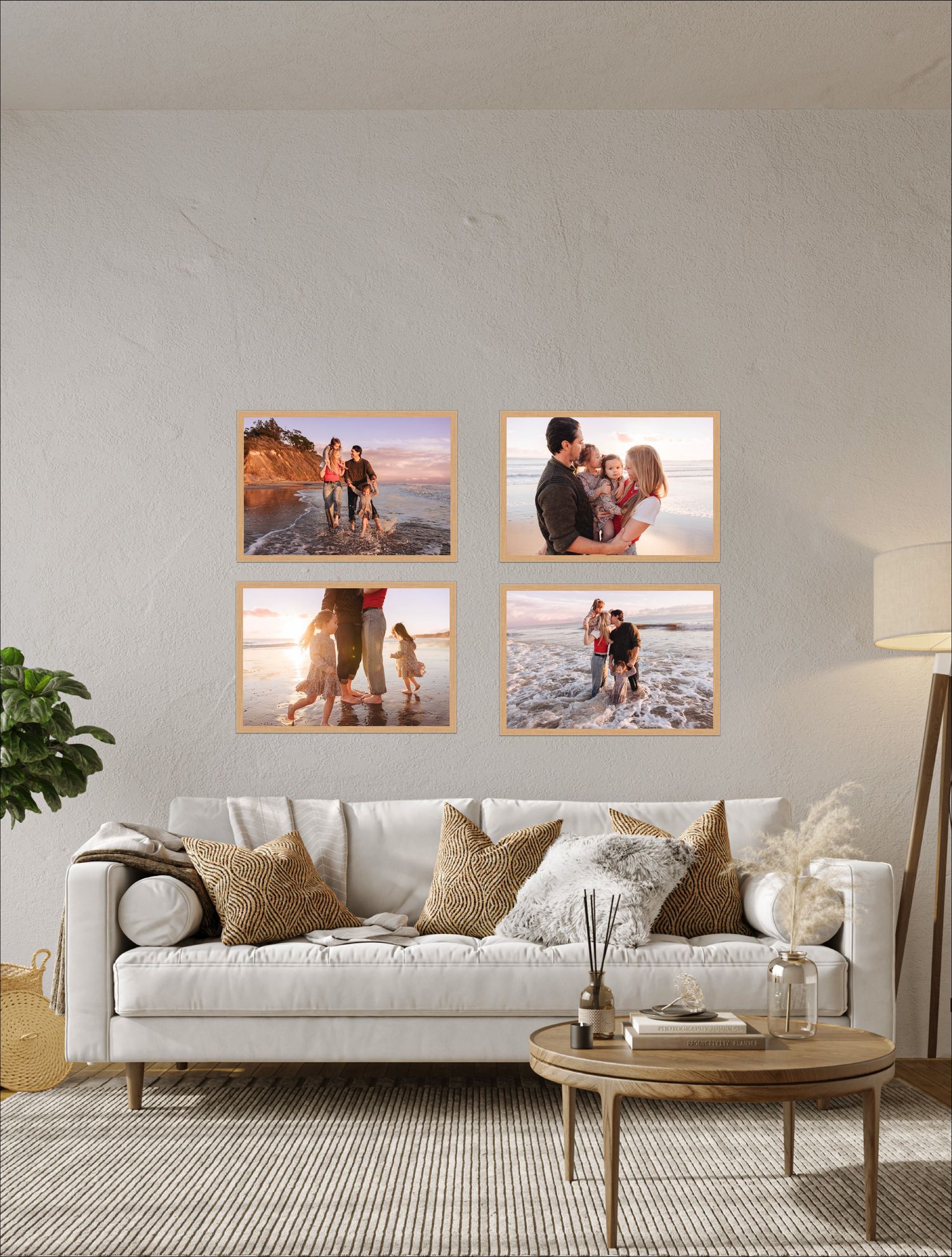 Modern living room interior with white sofa, decorative pillows, framed beach photos, and natural decor elements.