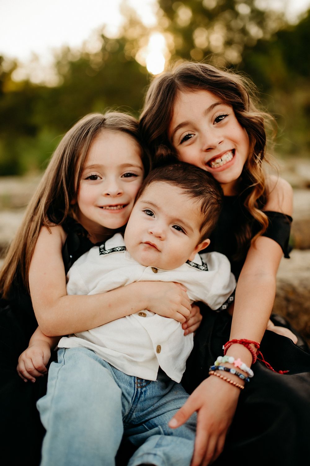 A series of candid outdoor family photos showing siblings embracing and playing together at sunset.