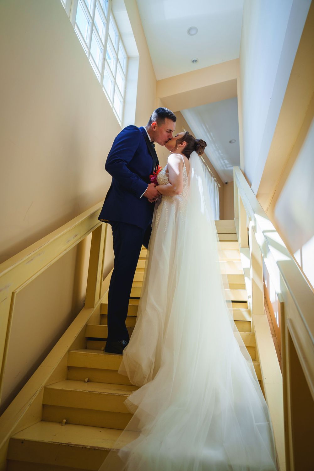 Romantic wedding couple shares intimate moment on staircase in series of progressive shots.