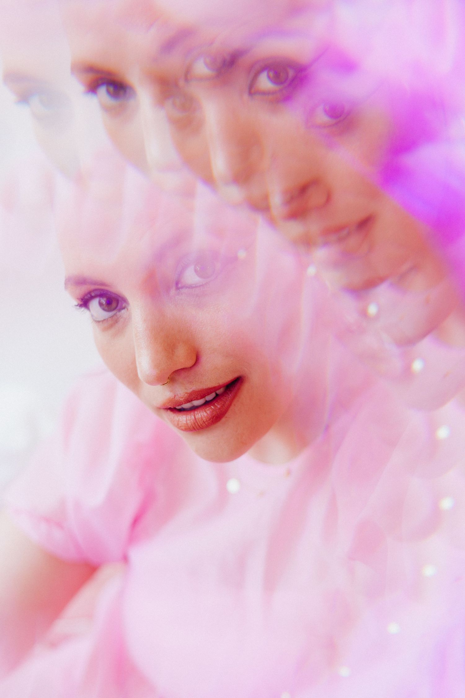 Dreamy pink and purple portrait series with ethereal lighting effects.