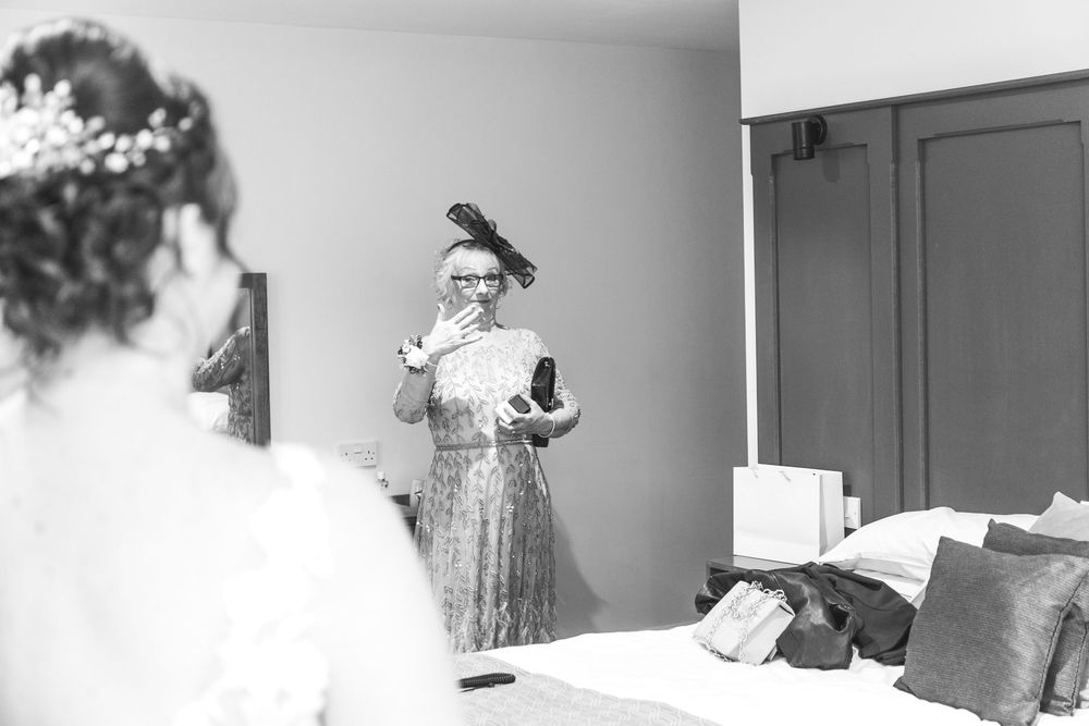 Black and white artistic wedding photography showing candid moments at a reception.