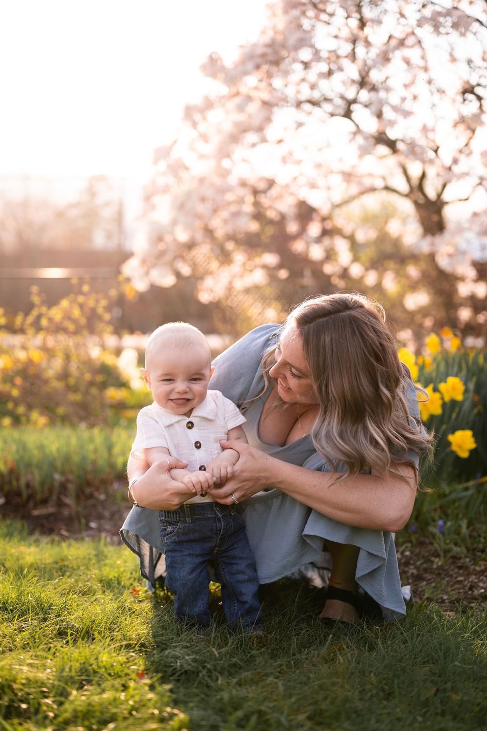 Sweet candid moments captured in a garden with blooming daffodils during golden hour.
