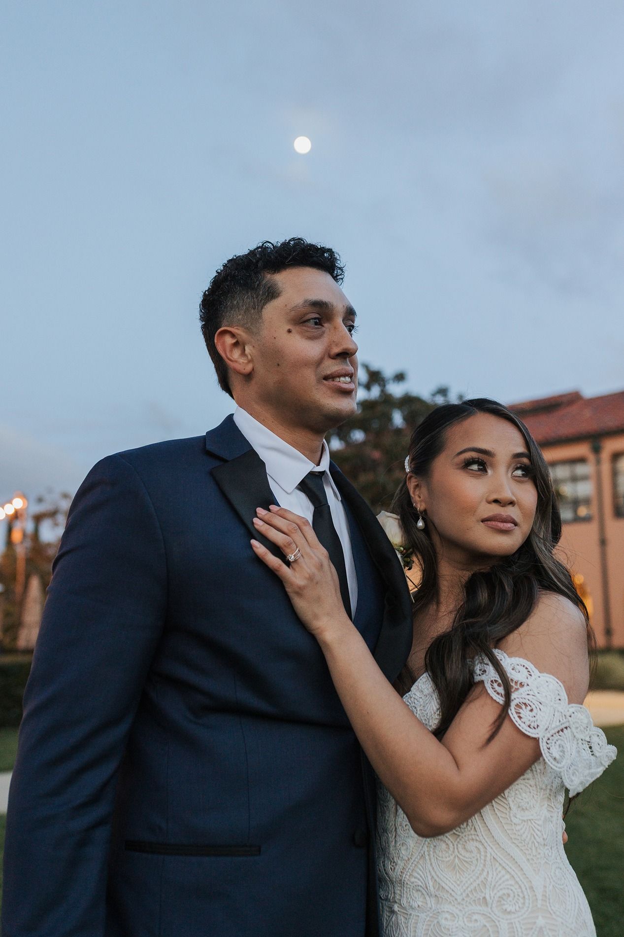 A romantic wedding couple poses together outdoors in a series of candid moments at sunset at Stone Brewing in San Diego.