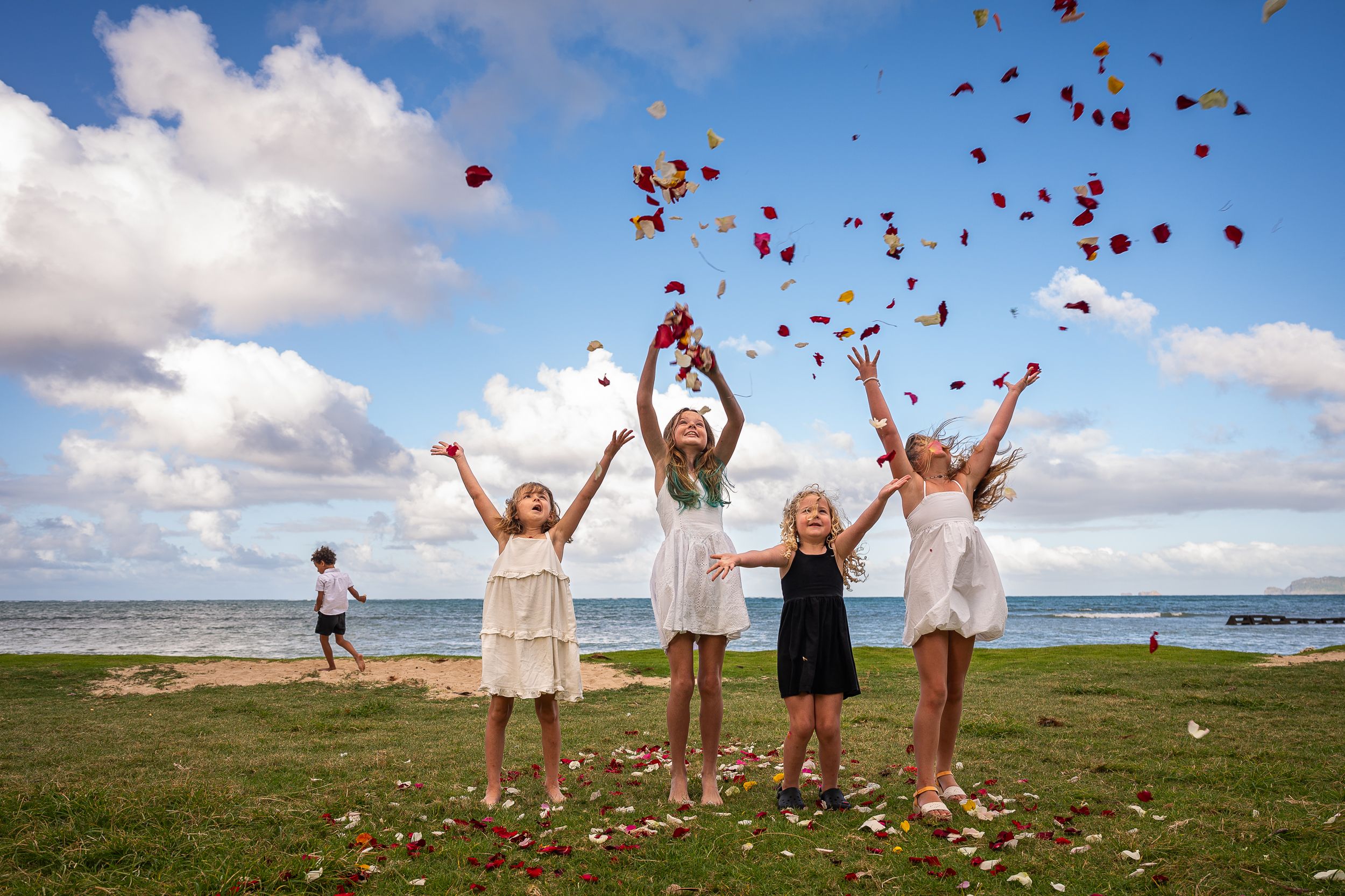 Children celebrating with rose petals and balloons celebrating grandpa and grandma's 50th anniversary photo session as an extended family