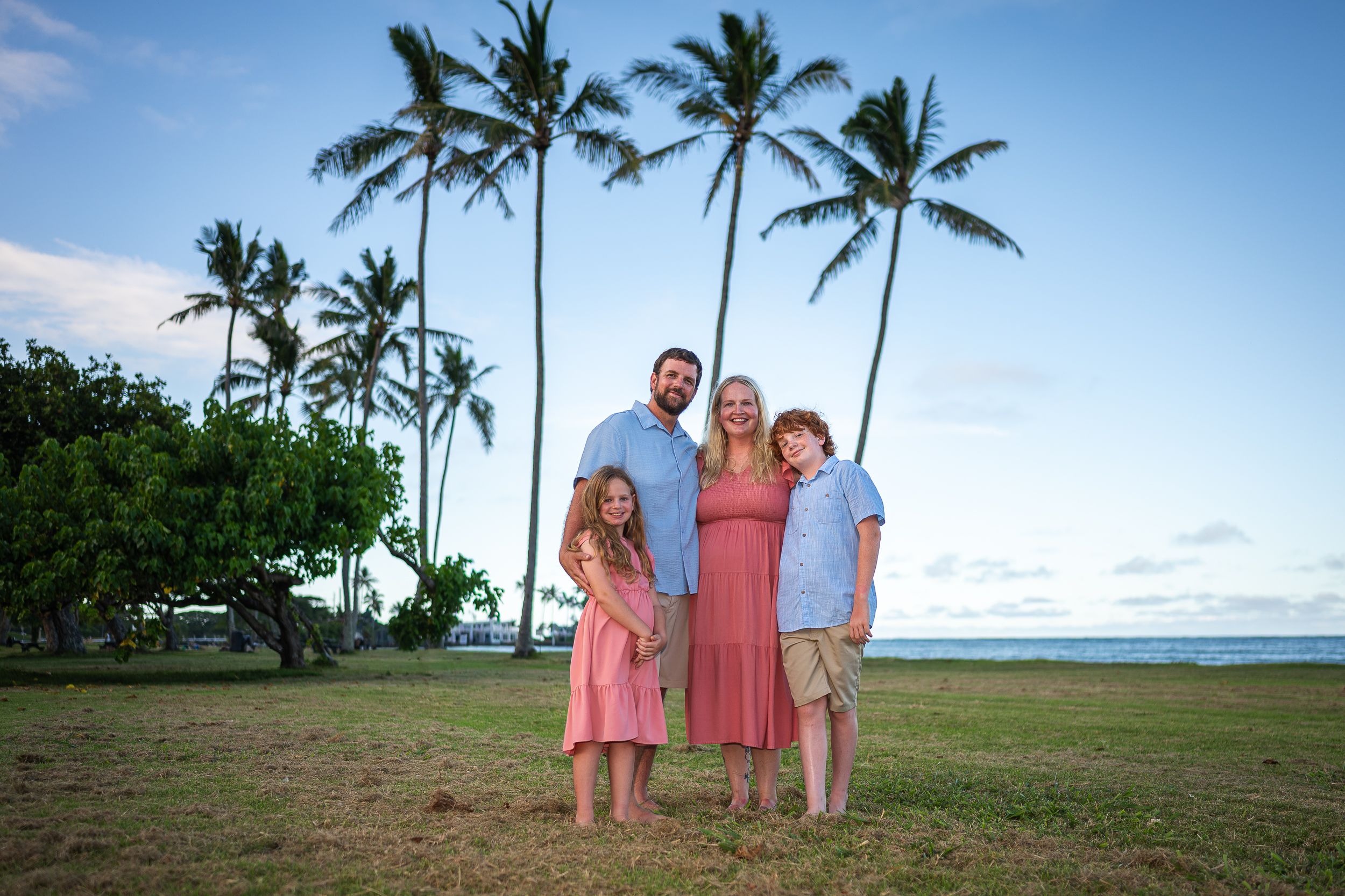 Vacationing tourist family of four getting fun fast family photos with military photographer Jenna Ettlich on Oahu windward side beautiful