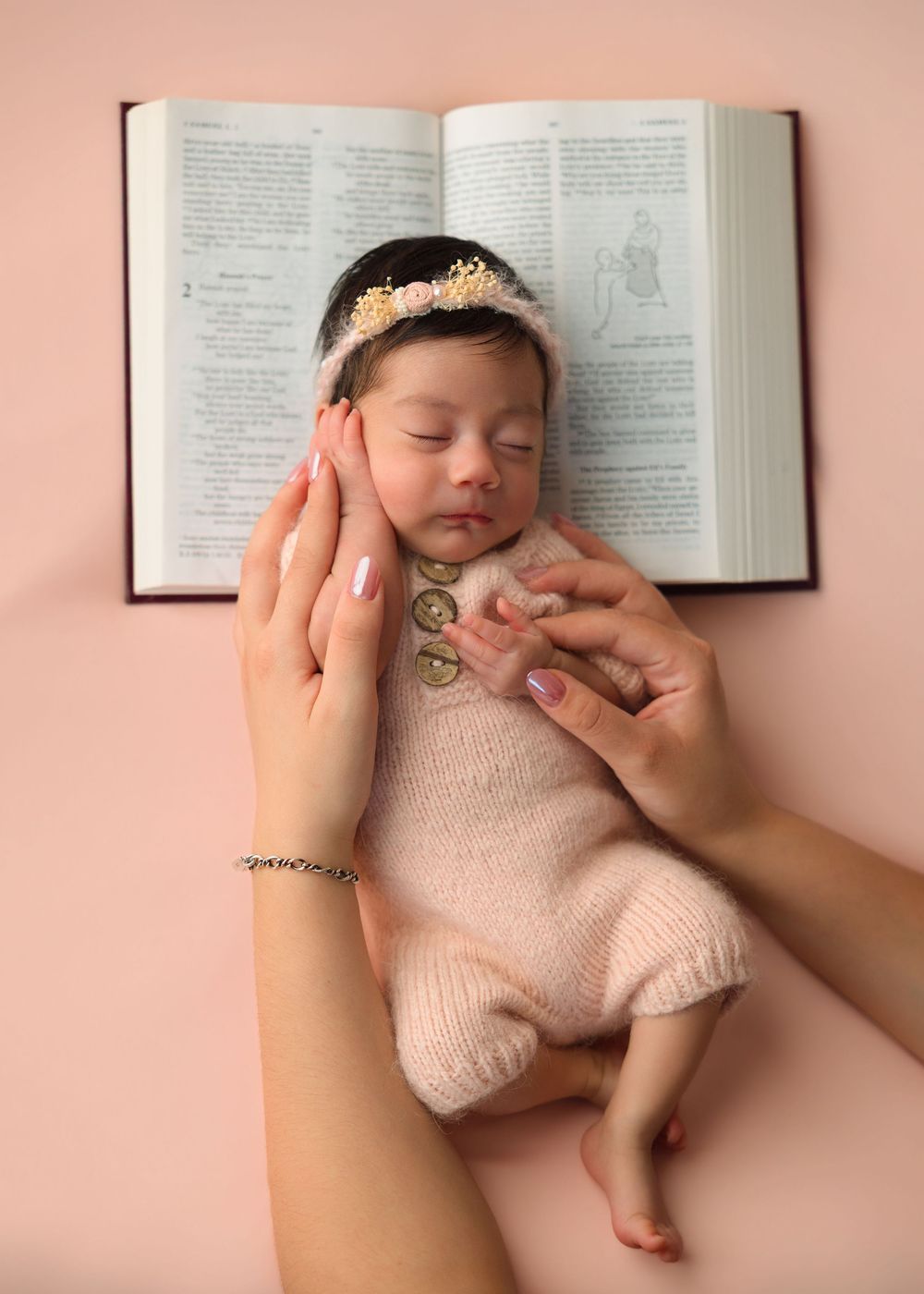 Mother holding her newborn baby during a studio newborn session