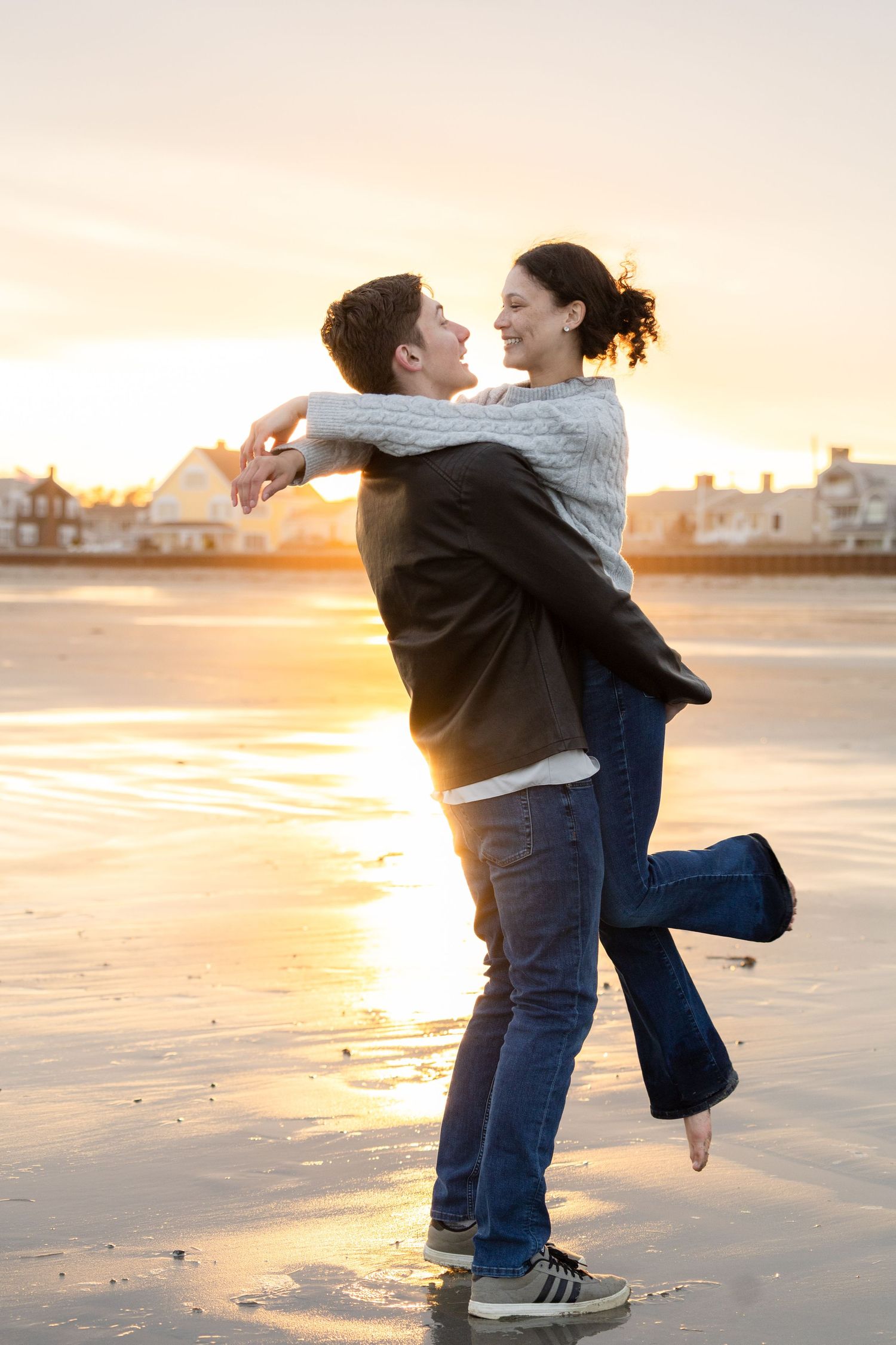 Couple embraces on a beach during golden sunset in a romantic series of candid moments.
