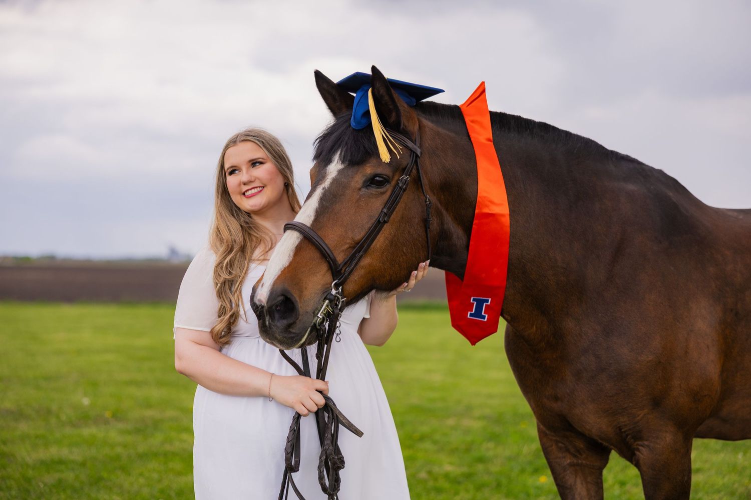 Girl with her horse wearing UIUC graduate accessories