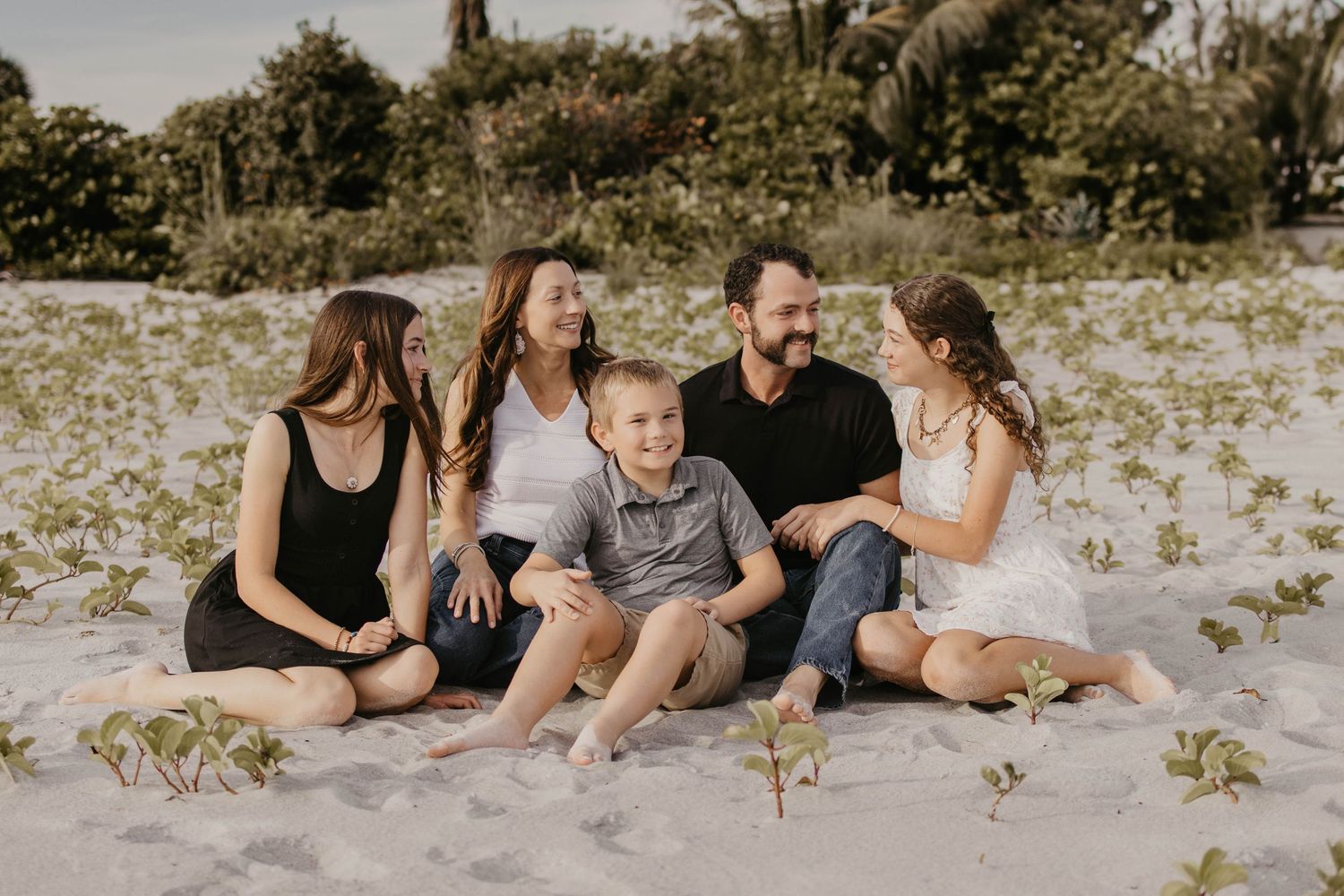 family photo sitting on the beach
