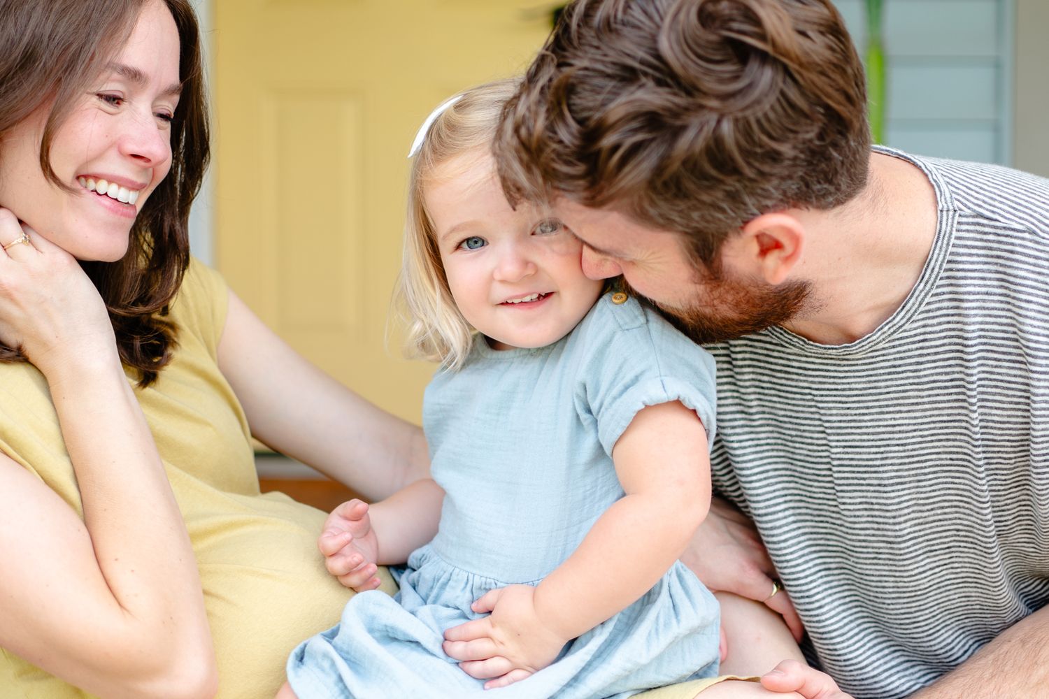 A joyful family moment shared on a their front porch during a casual afternoon.