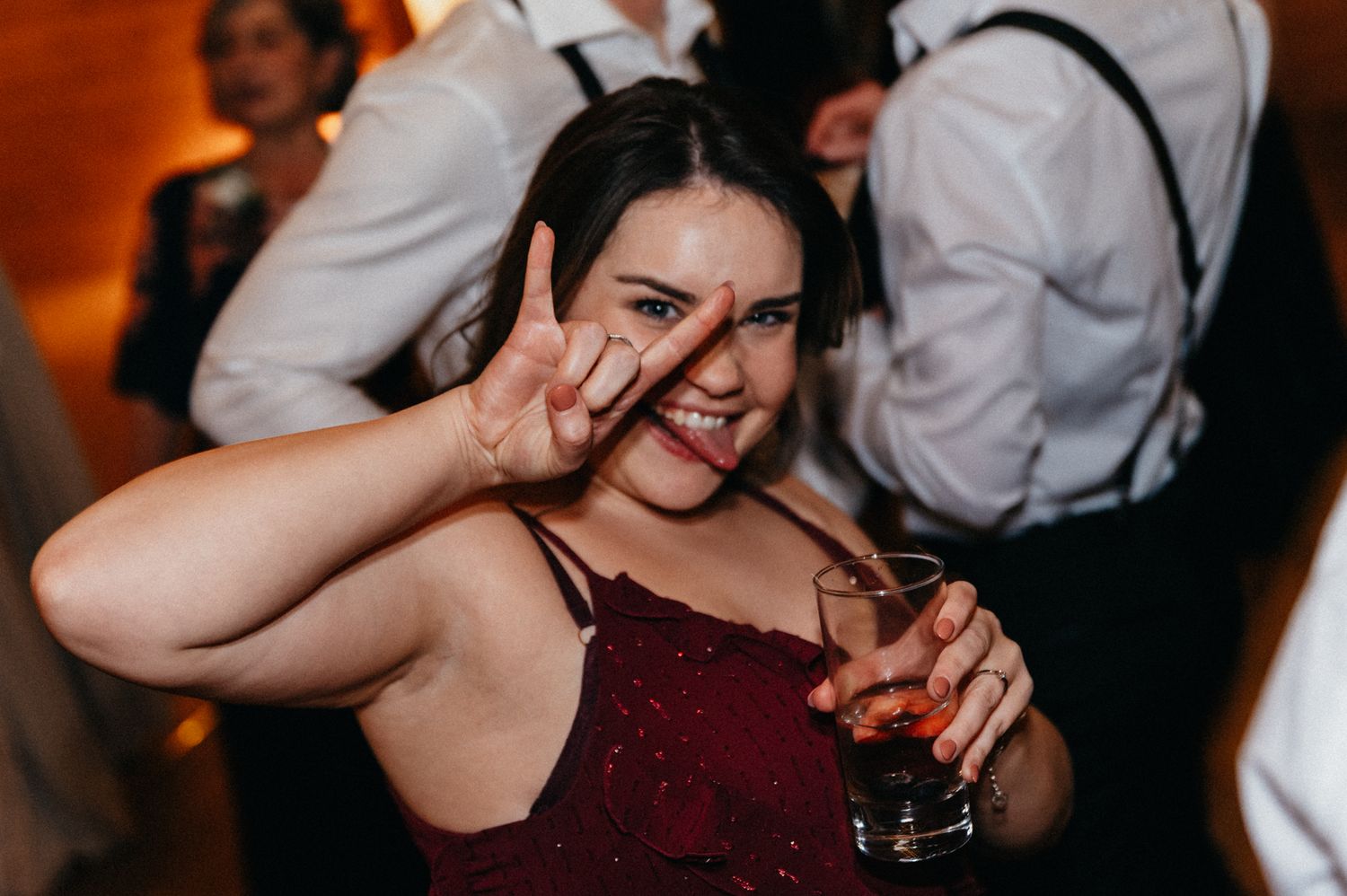 Wedding guests enjoying themselves during lively dance floor celebration.