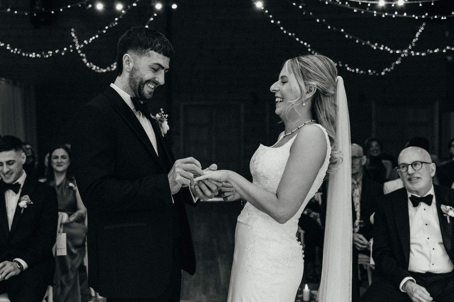 Wedding reception dance floor filled with guests under twinkling lights.