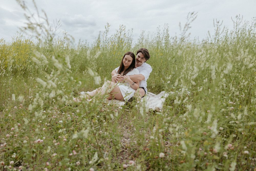 Couple enjoying a romantic moment together in a blooming spring meadow.