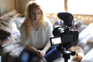 Indoor photography session setup with camera equipment and natural lighting.