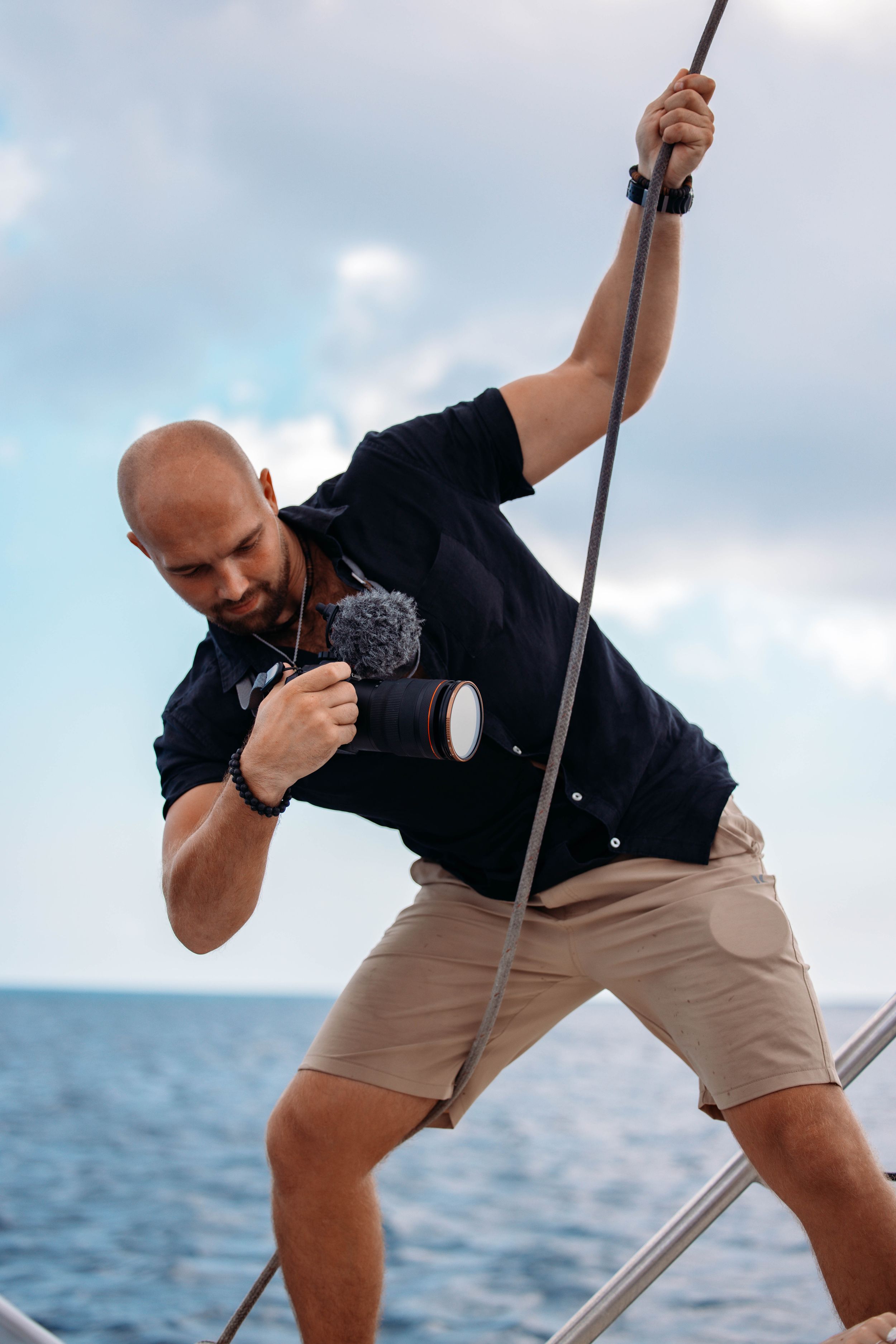 Multiple angles of a photographer taking creative shots from a boat deck against blue ocean waters.