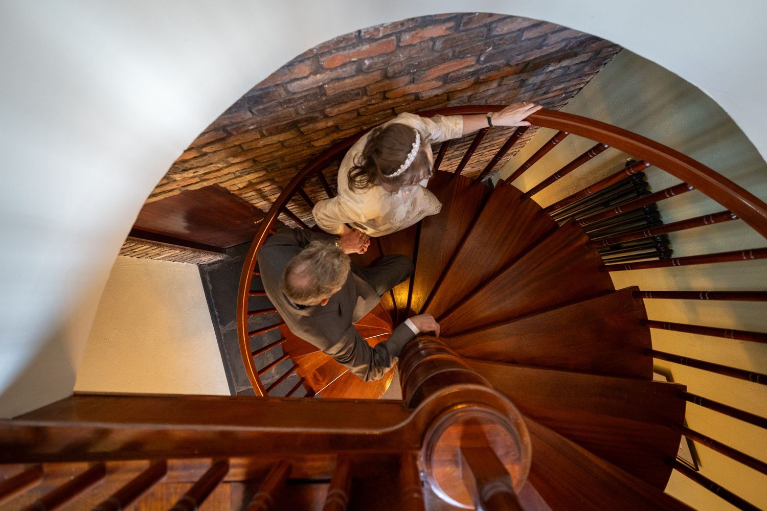 Overhead view of Dorothy and John walking up the spiral staircase inside the windmill at Windmill Farm in Burscough.