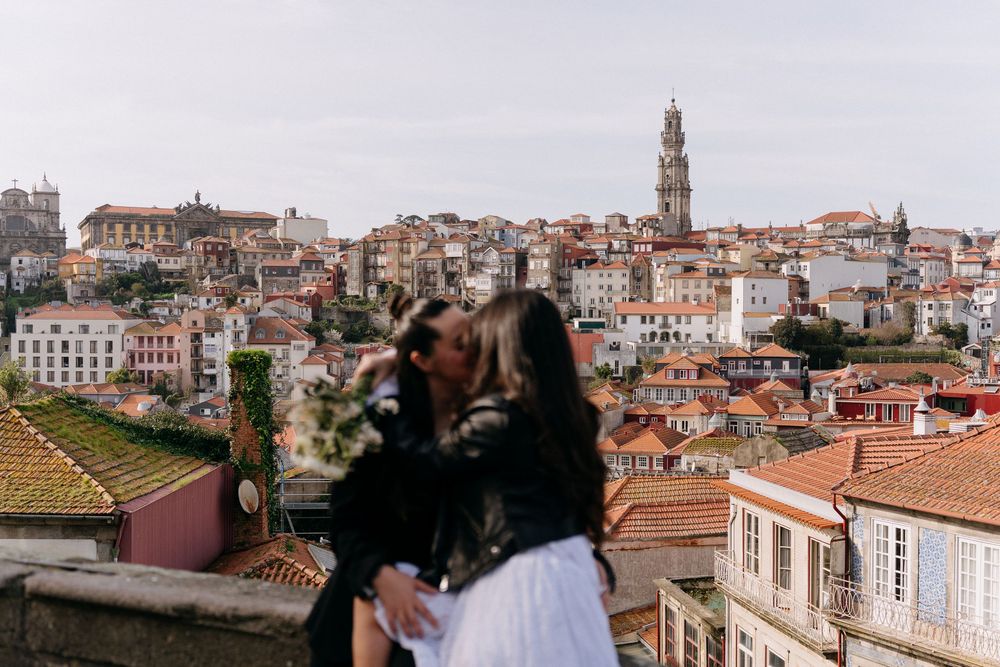 A panoramic view of Porto's historic skyline with terracotta roofs and church towers.