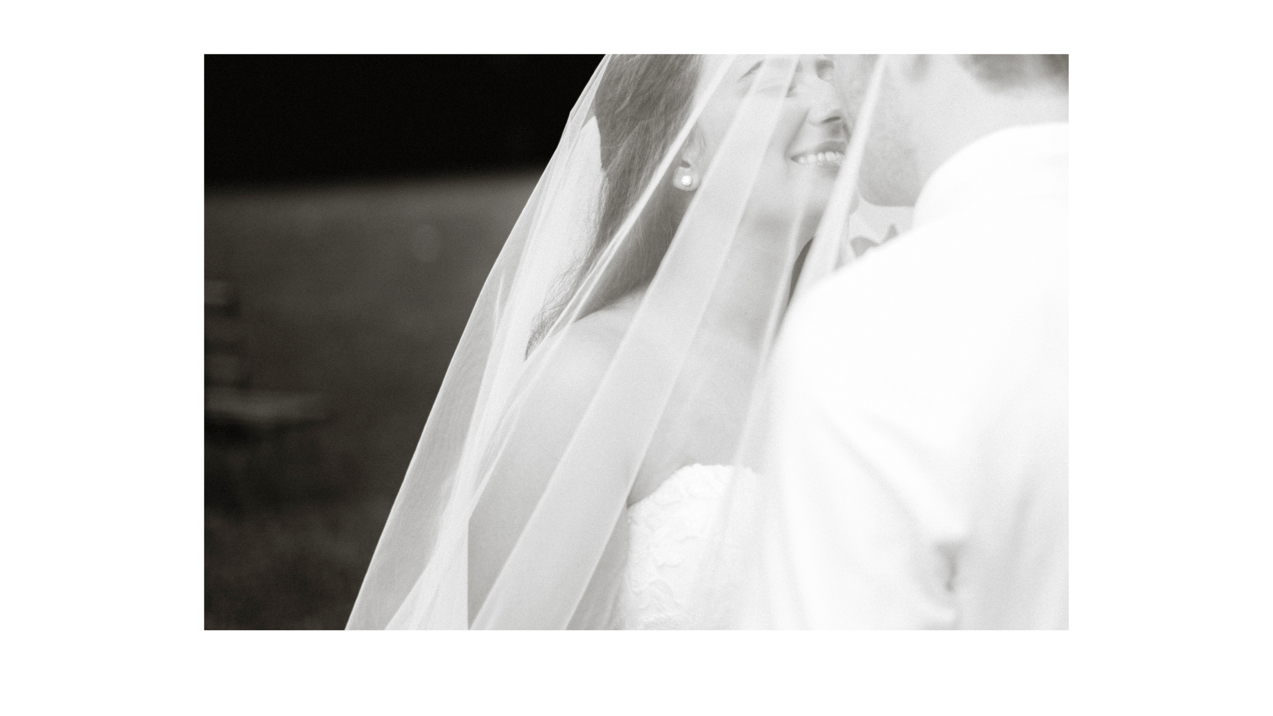 Close-up of delicate white wedding veil fabric details in black and white.