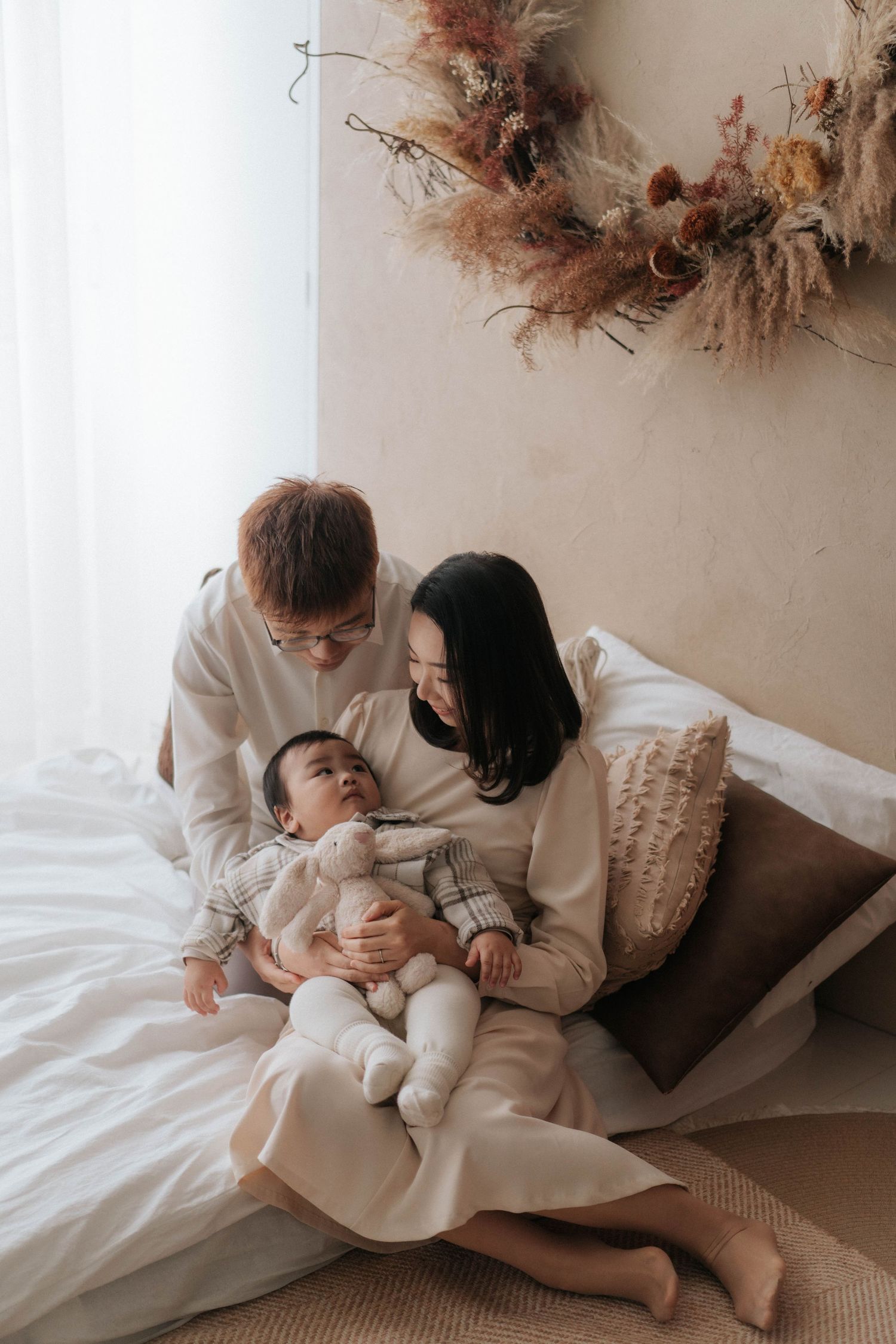 A series of intimate lifestyle photos showing tender moments between two people in light neutral colored clothing.