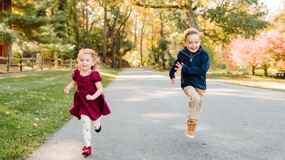 A sequence of six photos showing someone jumping and running on a paved path in an autumn park setting.