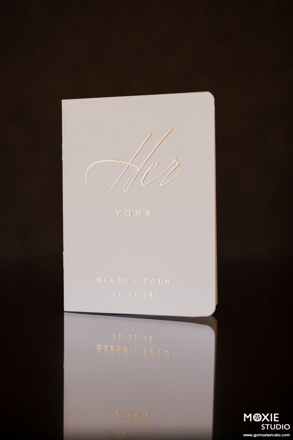 Elegant white business cards with gold foil lettering shown in a series of close-up product photography shots.