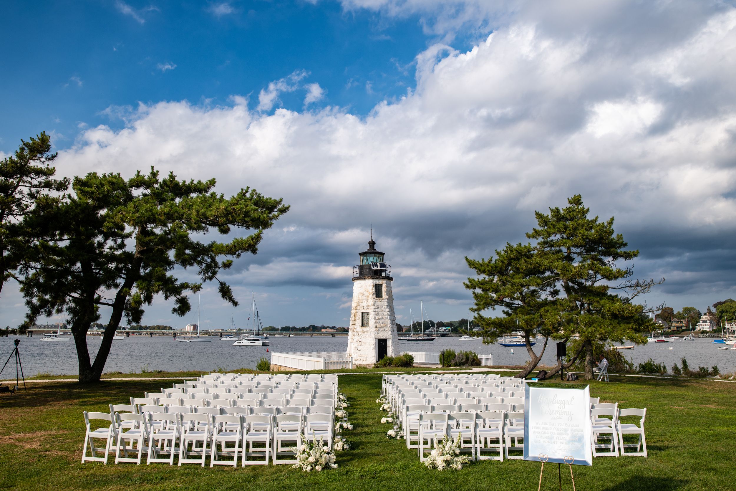 Wedding portraits by the Goat Island lighthouse at Newport Harbor Island Resort. Luxury RI waterfront wedding photography