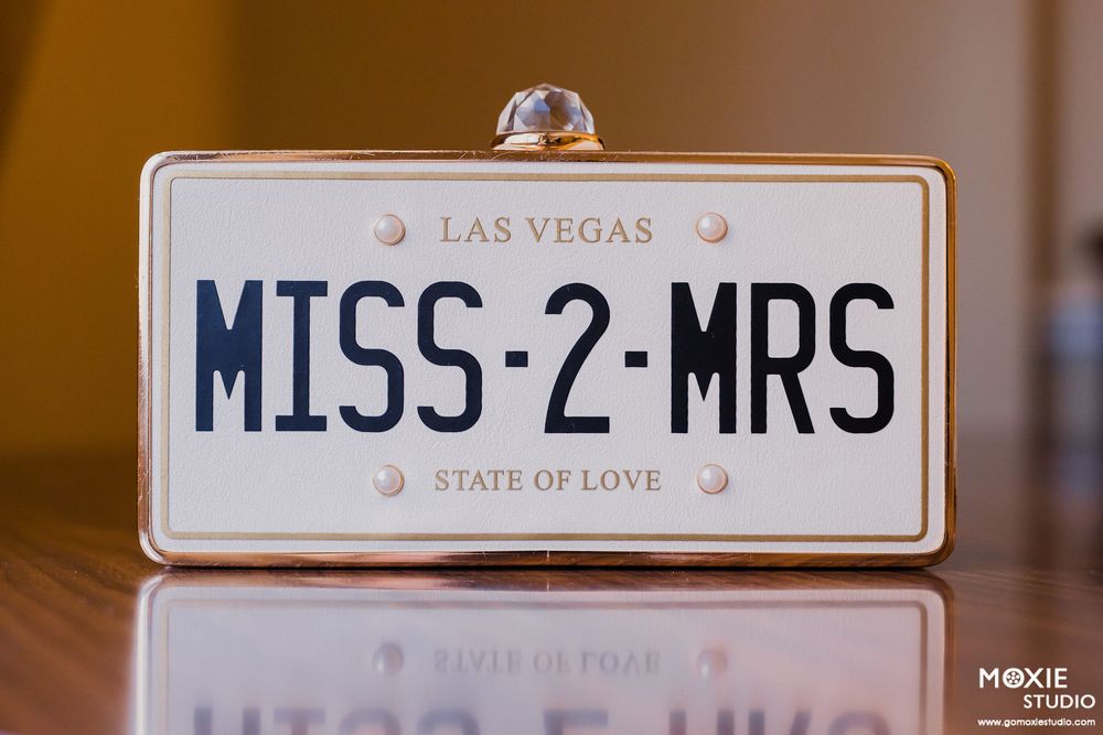 Nevada license plates displayed in a row on a brown wooden surface.